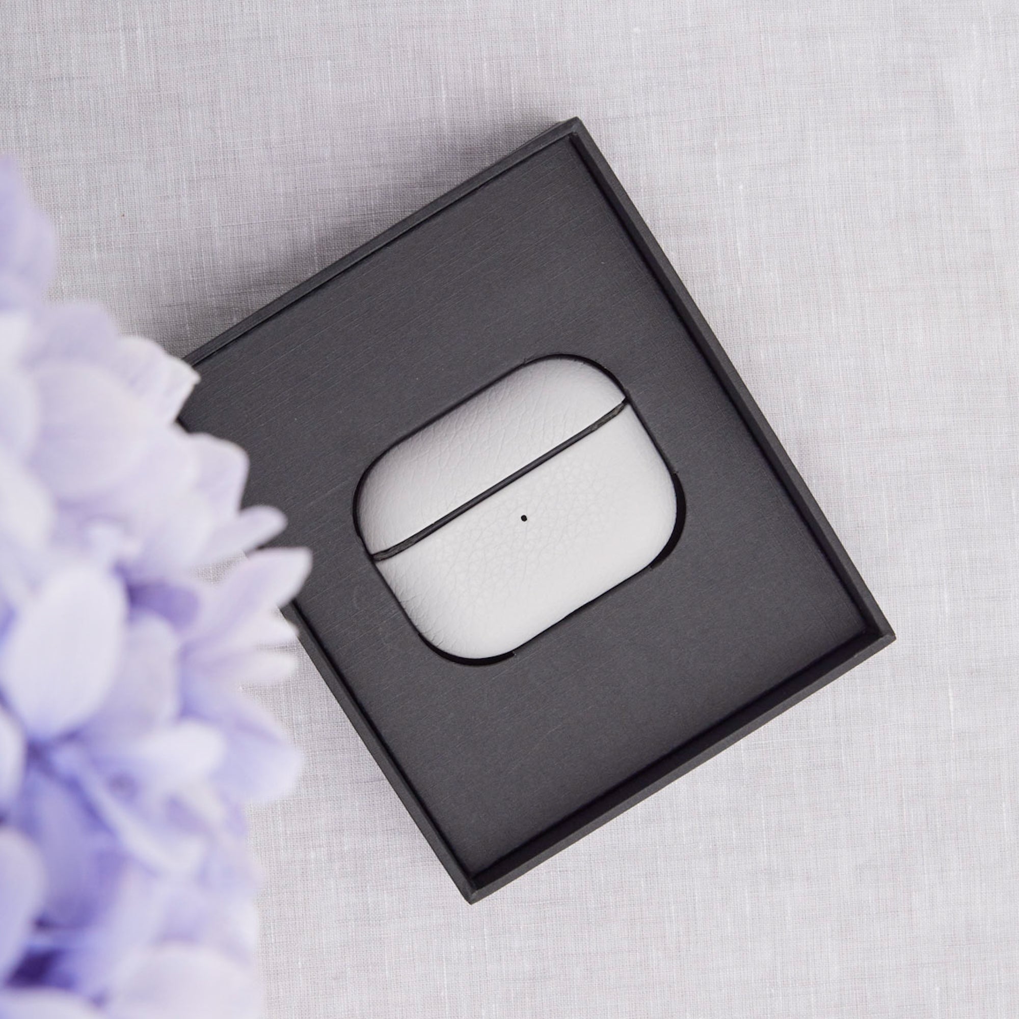 Ubique Italy Luxury AirPods Pro 2 Case Pebble Grain Leather Venetian Grey in grey box on linen background