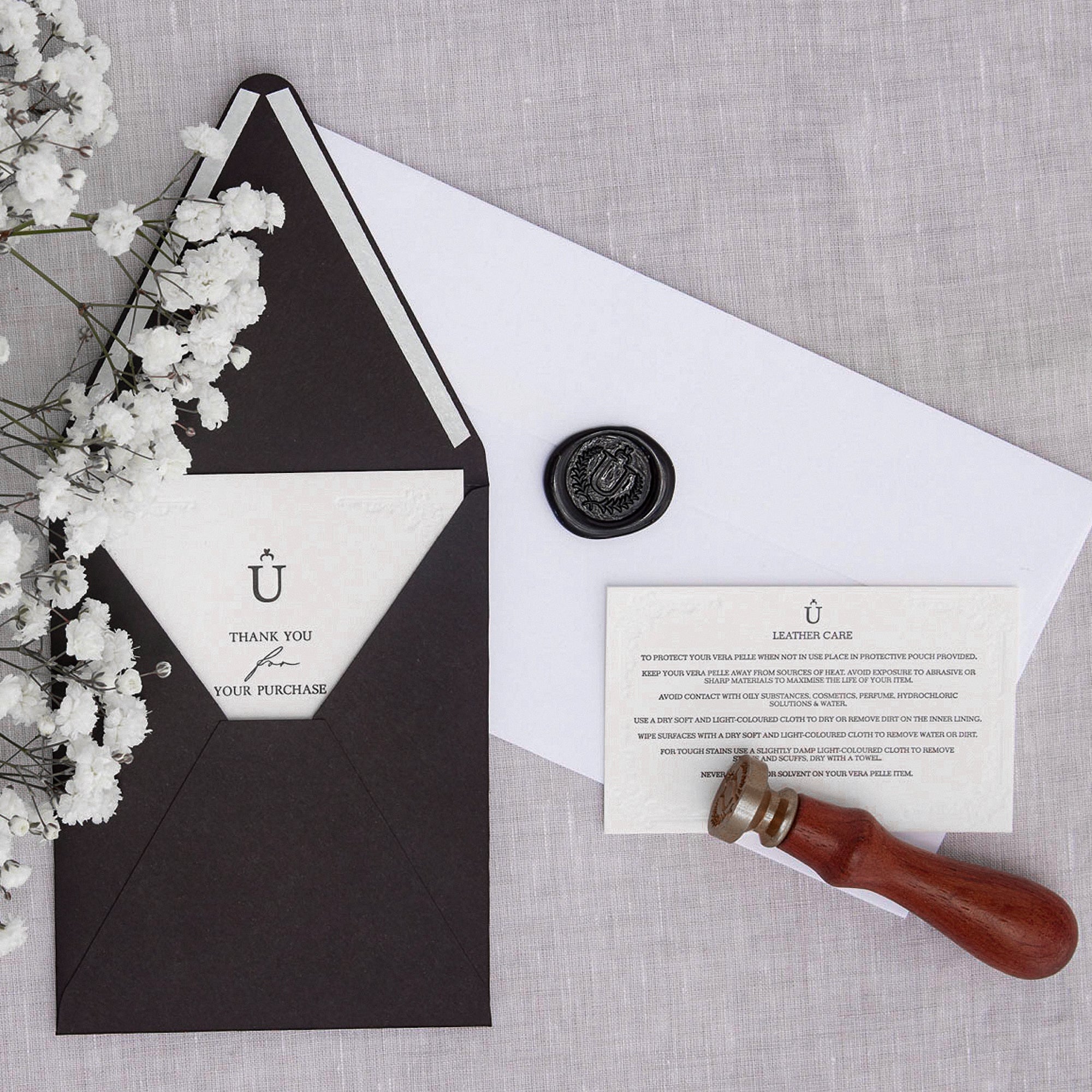 Ubique Italy thank you card, leather care card and envelope with wax seal.