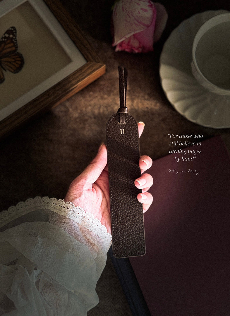 hand holding a handcrafted leather bookmark